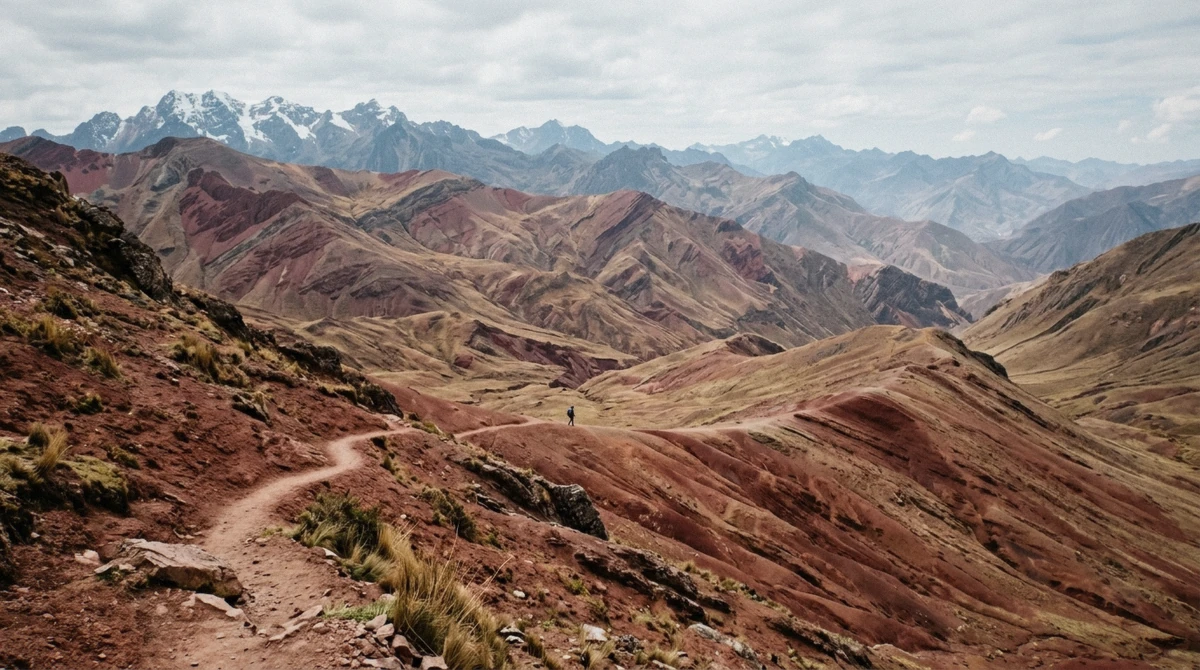 Crimson and ochre slopes of Red Valley beside the Vinicunca ridge on a rainbow mountain peru tour in the Cusco region