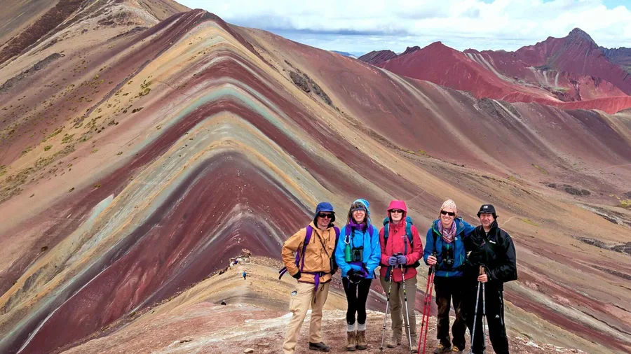 Red Valley crimson slopes seen from the ridge above Vinicunca on a premium rainbow mountain peru tour near Cusco